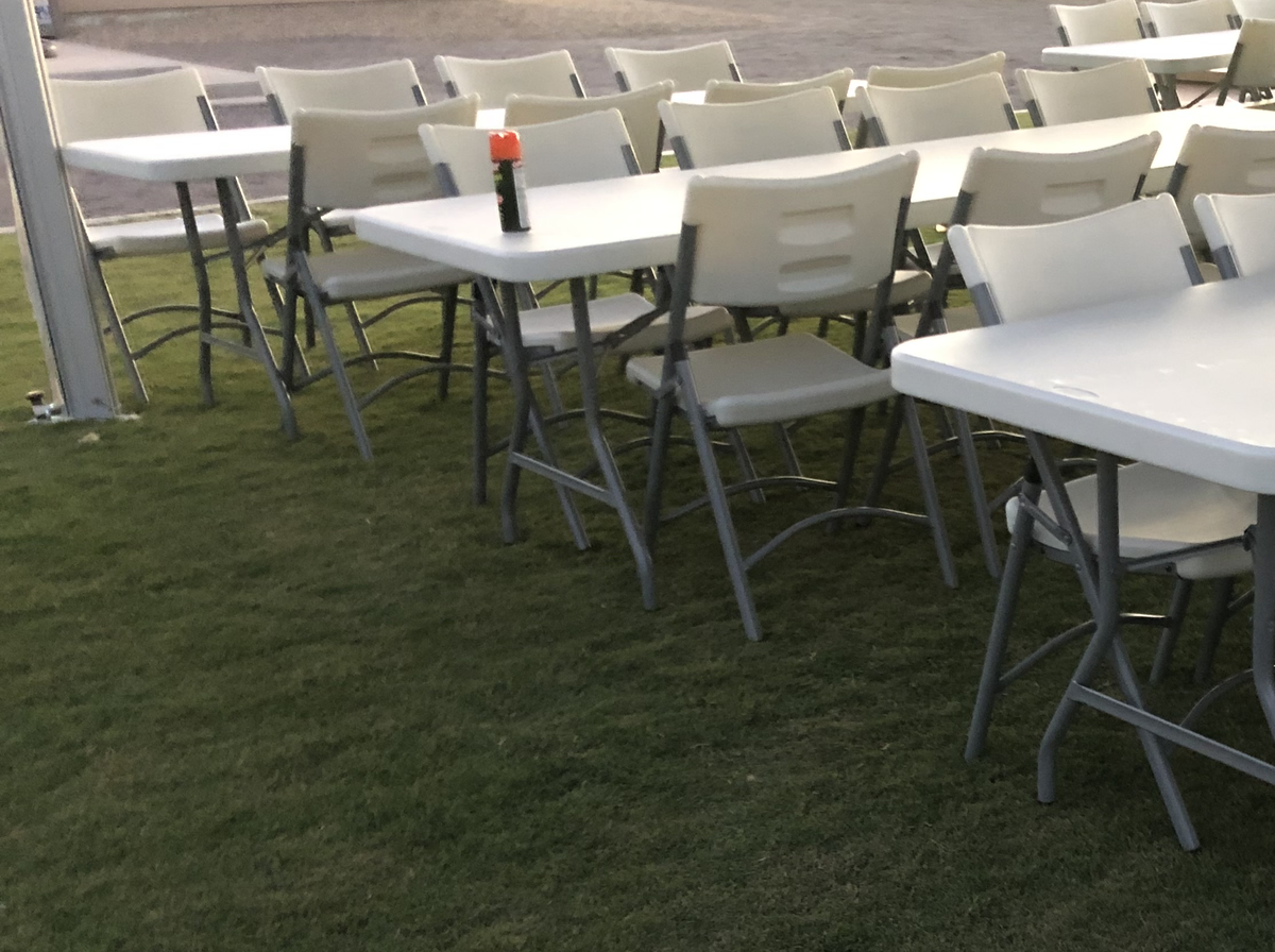 Rows of white folding event chairs